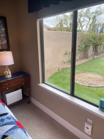 a bedroom with a bed and a window