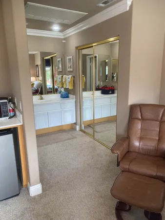 a living room with furniture and a mirror