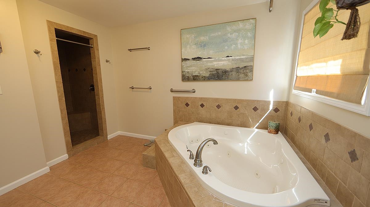 3016 Old Orchard Road Raleigh, NC 27607 - Photo 17 of 39 Walk In Shower with Dual Shower Heads and Convenient Built In Bench Seat. Owner's Spa Bath Walk In Shower