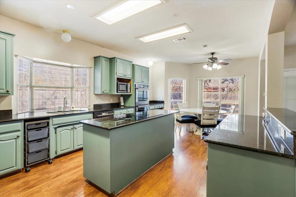 227 North Hopson Street Van Alstyne, TX 75495 - Photo 11 of 38 a kitchen with a sink stove and cabinets