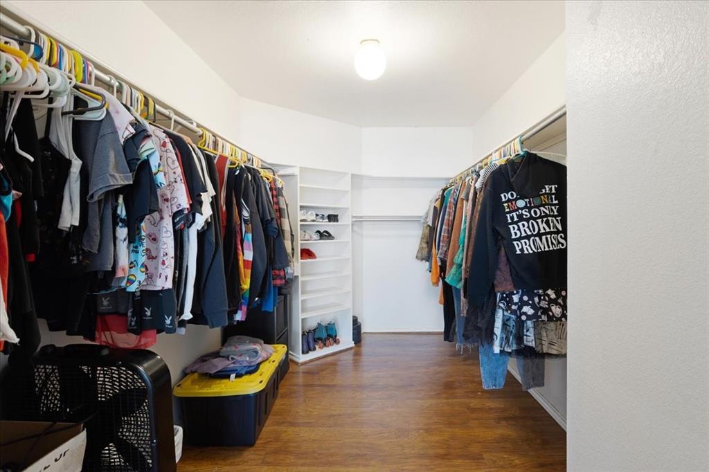 227 North Hopson Street Van Alstyne, TX 75495 - Photo 13 of 38 a view of walk in closet with clothes and shoes