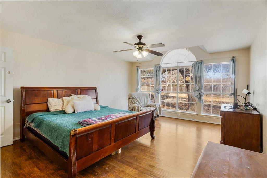 227 North Hopson Street Van Alstyne, TX 75495 - Photo 14 of 38 a bedroom with a bed and a couch