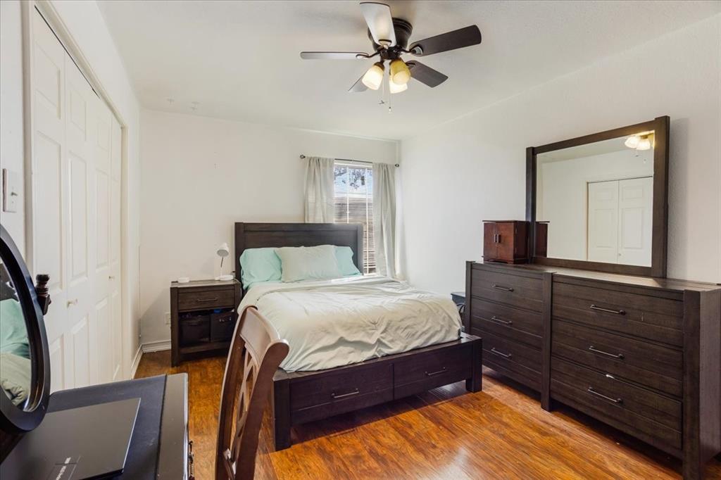 227 North Hopson Street Van Alstyne, TX 75495 - Photo 15 of 38 a bedroom with a bed a chandelier and a dresser