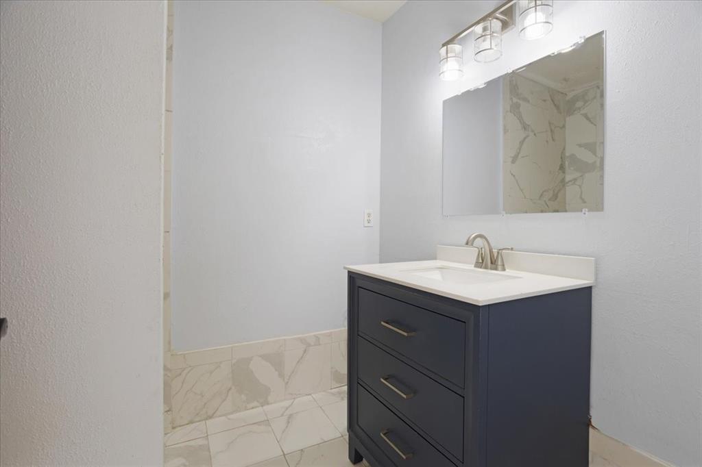 227 North Hopson Street Van Alstyne, TX 75495 - Photo 20 of 38 a bathroom with a sink and mirror