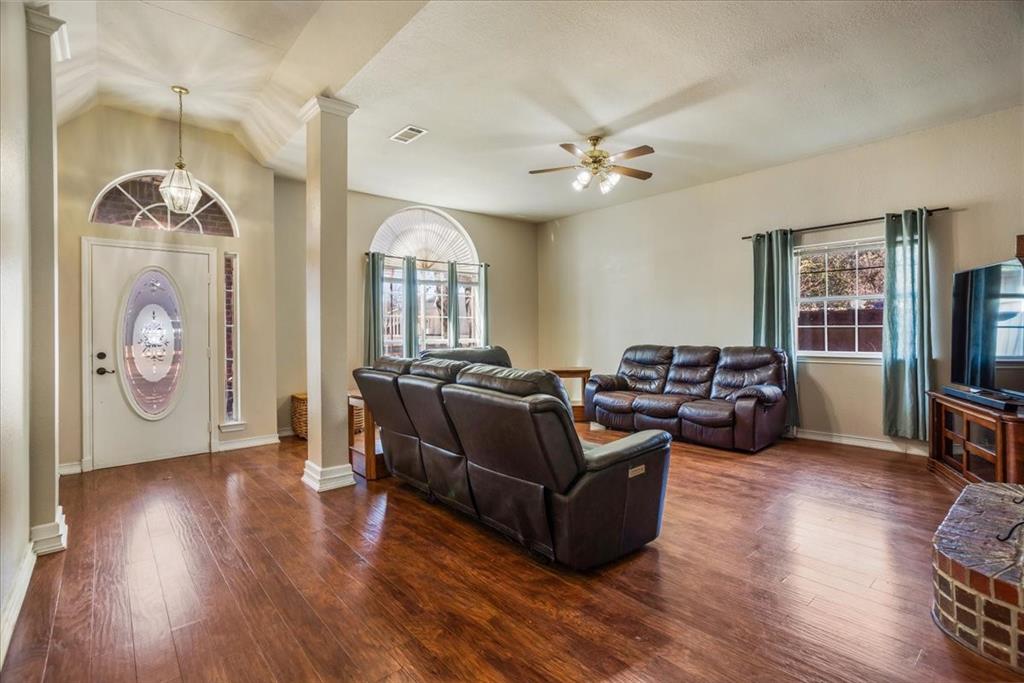 227 North Hopson Street Van Alstyne, TX 75495 - Photo 2 of 38 a living room with furniture a ceiling fan and a wooden floor
