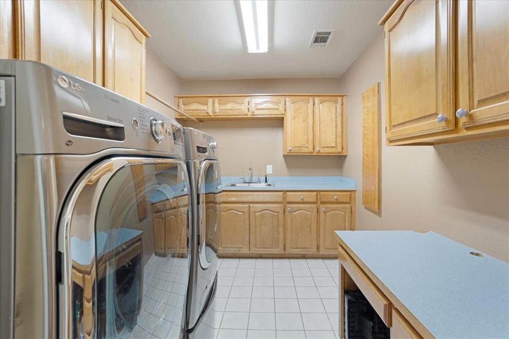227 North Hopson Street Van Alstyne, TX 75495 - Photo 21 of 38 a kitchen with a cabinets and white appliances