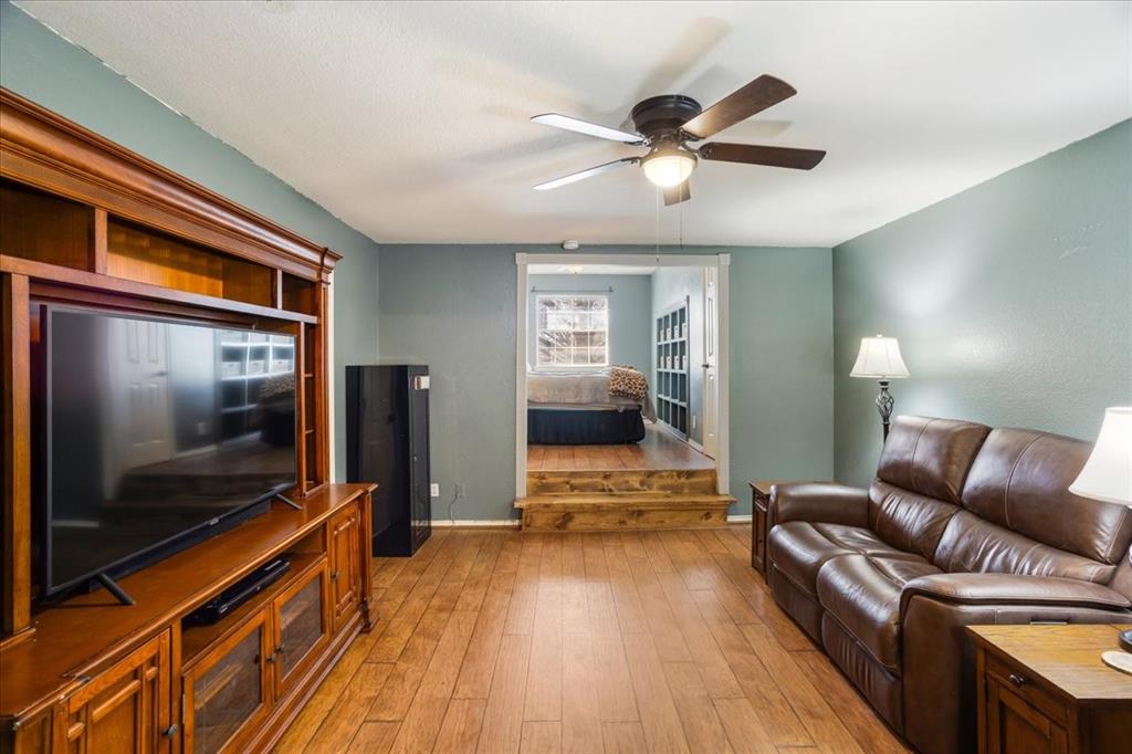 227 North Hopson Street Van Alstyne, TX 75495 - Photo 25 of 38 a living room with furniture and a flat screen tv