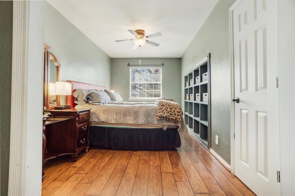 227 North Hopson Street Van Alstyne, TX 75495 - Photo 26 of 38 a bedroom with a bed and wooden floor