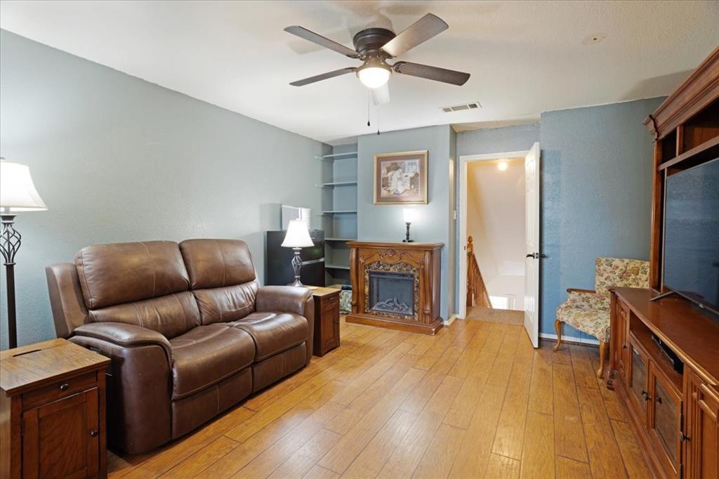 227 North Hopson Street Van Alstyne, TX 75495 - Photo 27 of 38 a living room with furniture and a flat screen tv