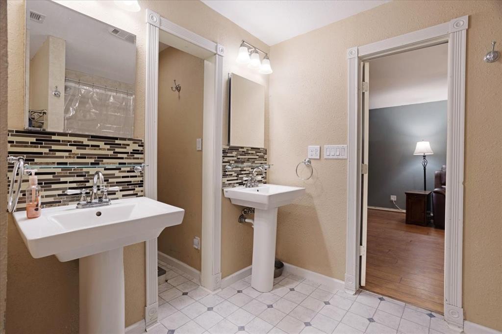 227 North Hopson Street Van Alstyne, TX 75495 - Photo 29 of 38 a bathroom with a sink a toilet and shower
