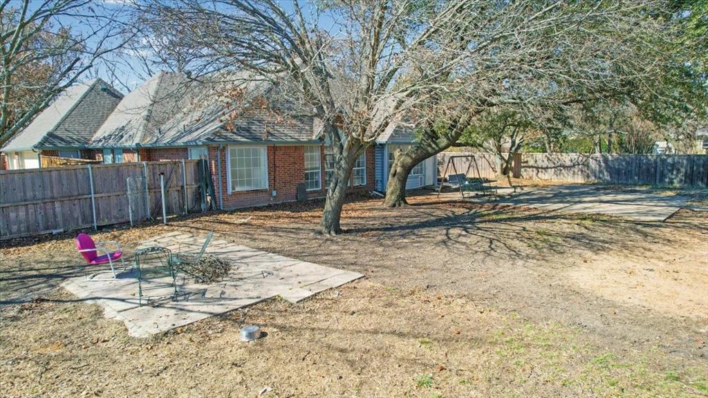 227 North Hopson Street Van Alstyne, TX 75495 - Photo 33 of 38 a view of a yard with a tree