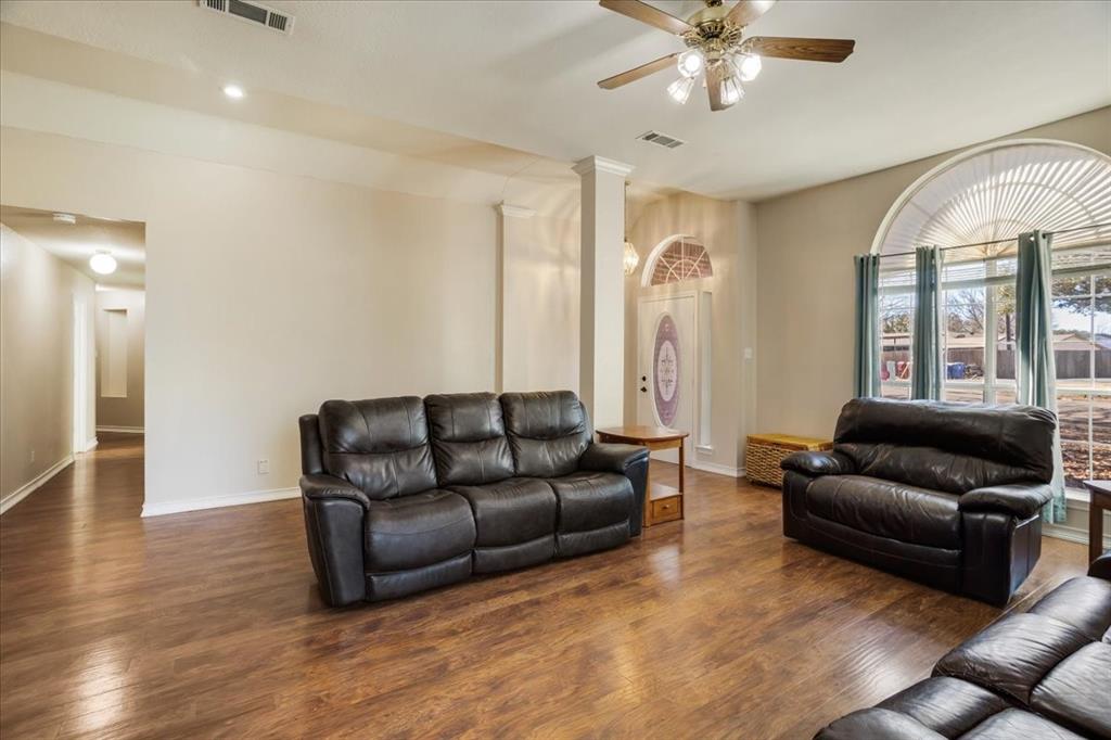 227 North Hopson Street Van Alstyne, TX 75495 - Photo 4 of 38 a living room with furniture and a large window