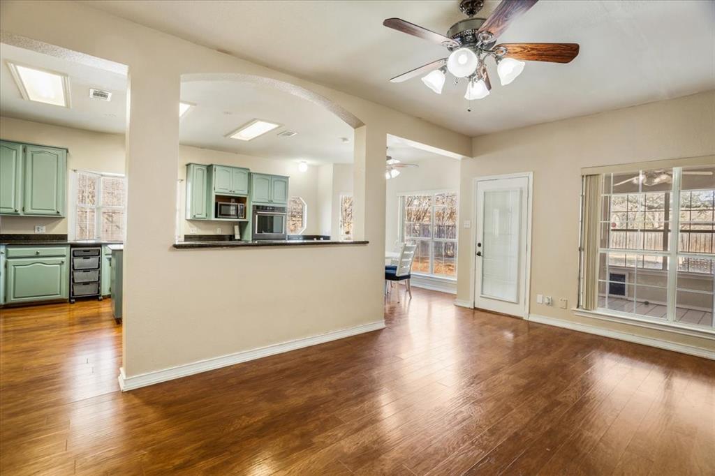 227 North Hopson Street Van Alstyne, TX 75495 - Photo 7 of 38 a view of a kitchen with wooden floor and a kitchen