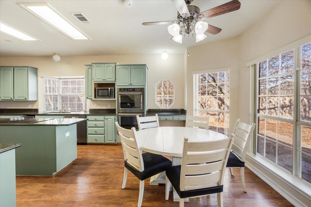 227 North Hopson Street Van Alstyne, TX 75495 - Photo 8 of 38 a view of a dining room with furniture window and wooden floor
