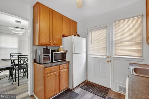 a kitchen with stainless steel appliances a refrigerator sink and cabinets
