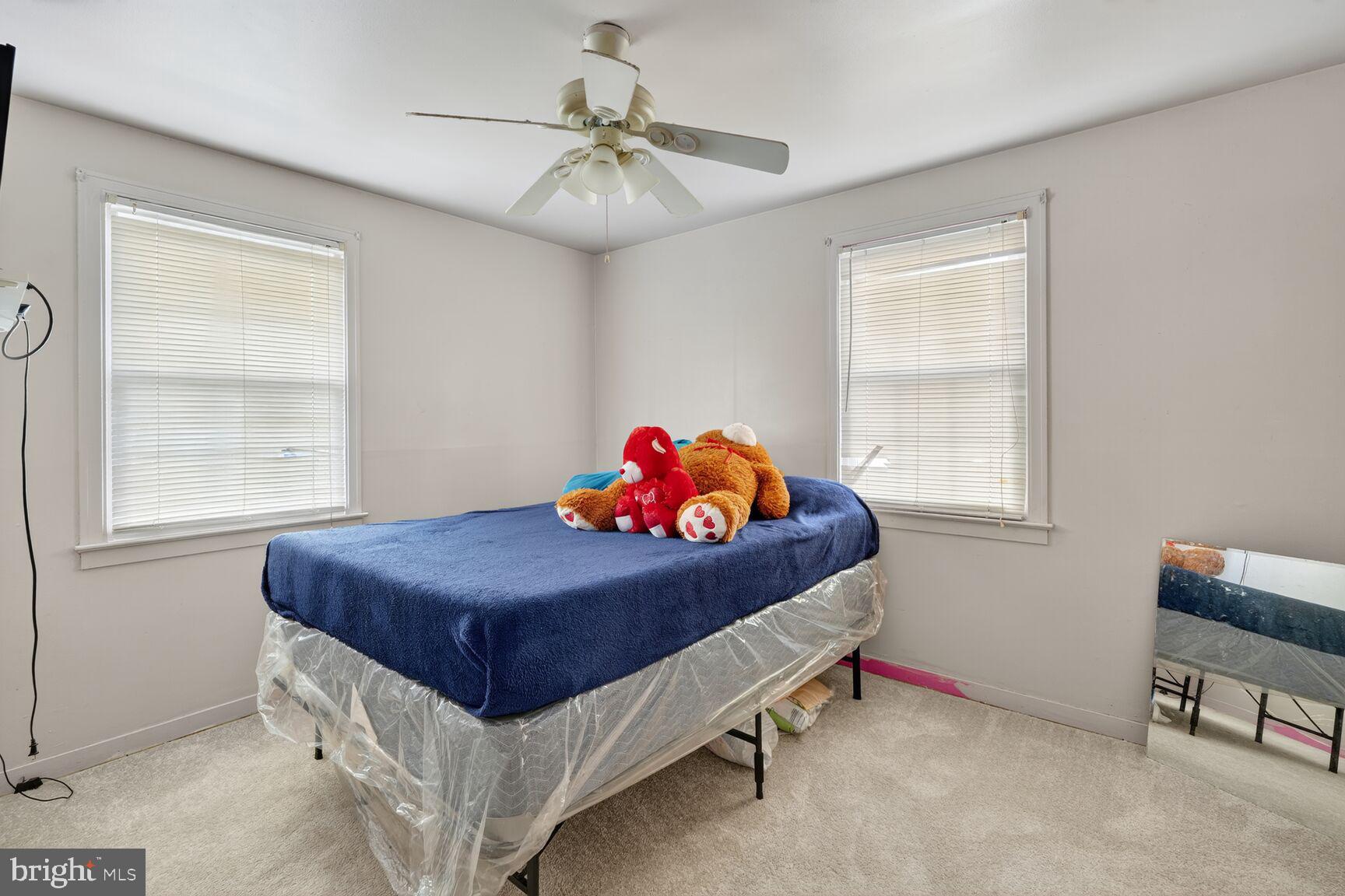 4513 Akron Street Temple Hills, MD 20748 - Photo 10 of 15 a bedroom with a bed and a chandelier