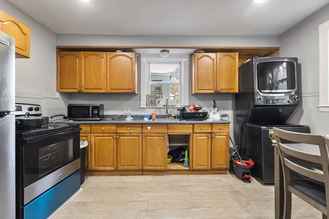 a kitchen with stainless steel appliances granite countertop a stove a sink and a microwave