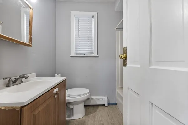 a bathroom with a sink a toilet and a mirror