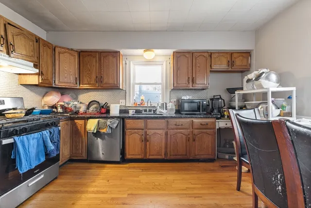 a kitchen with granite countertop a sink cabinets and window