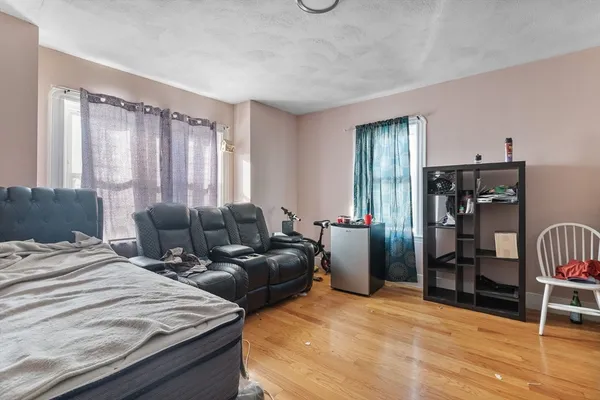 a bedroom with furniture and a window