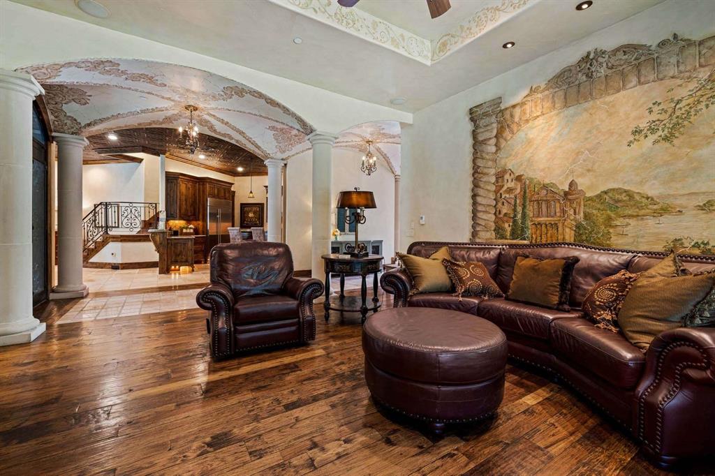 2115 Paradise Rnch Trail McKinney, TX 75071 - Photo 28 of 40 Living space featuring wood-finish flooring, a detailed wall mural, and a coffered ceiling with decorative accents