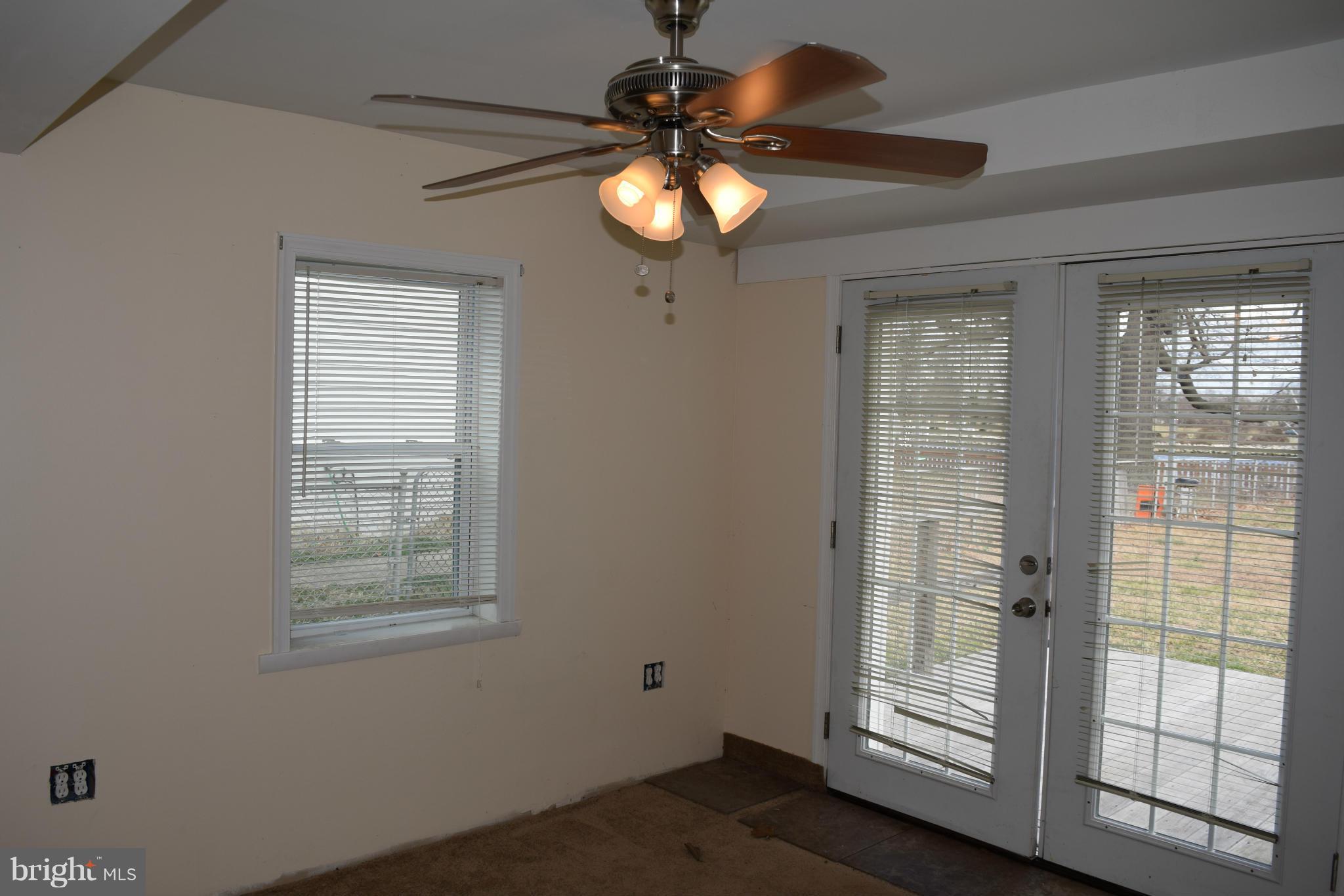 7737 Fairgreen Road Baltimore, MD 21222 - Photo 12 of 28 a chandelier fan and window in a room