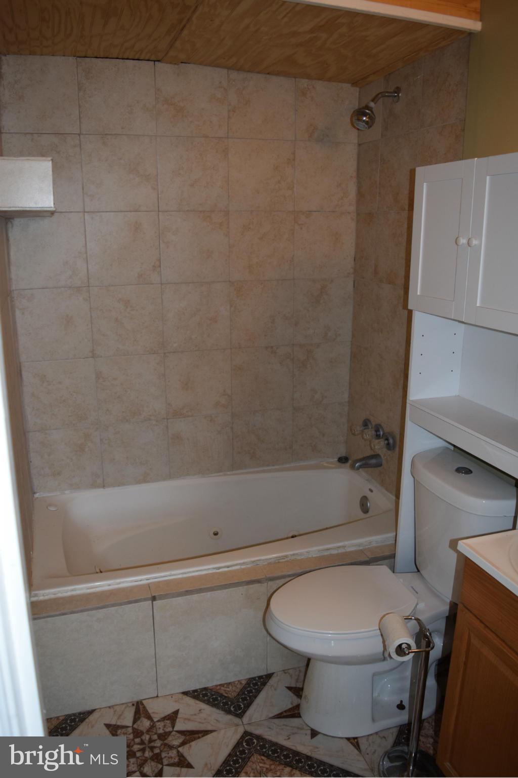 7737 Fairgreen Road Baltimore, MD 21222 - Photo 13 of 28 a bathroom with a toilet and a shower