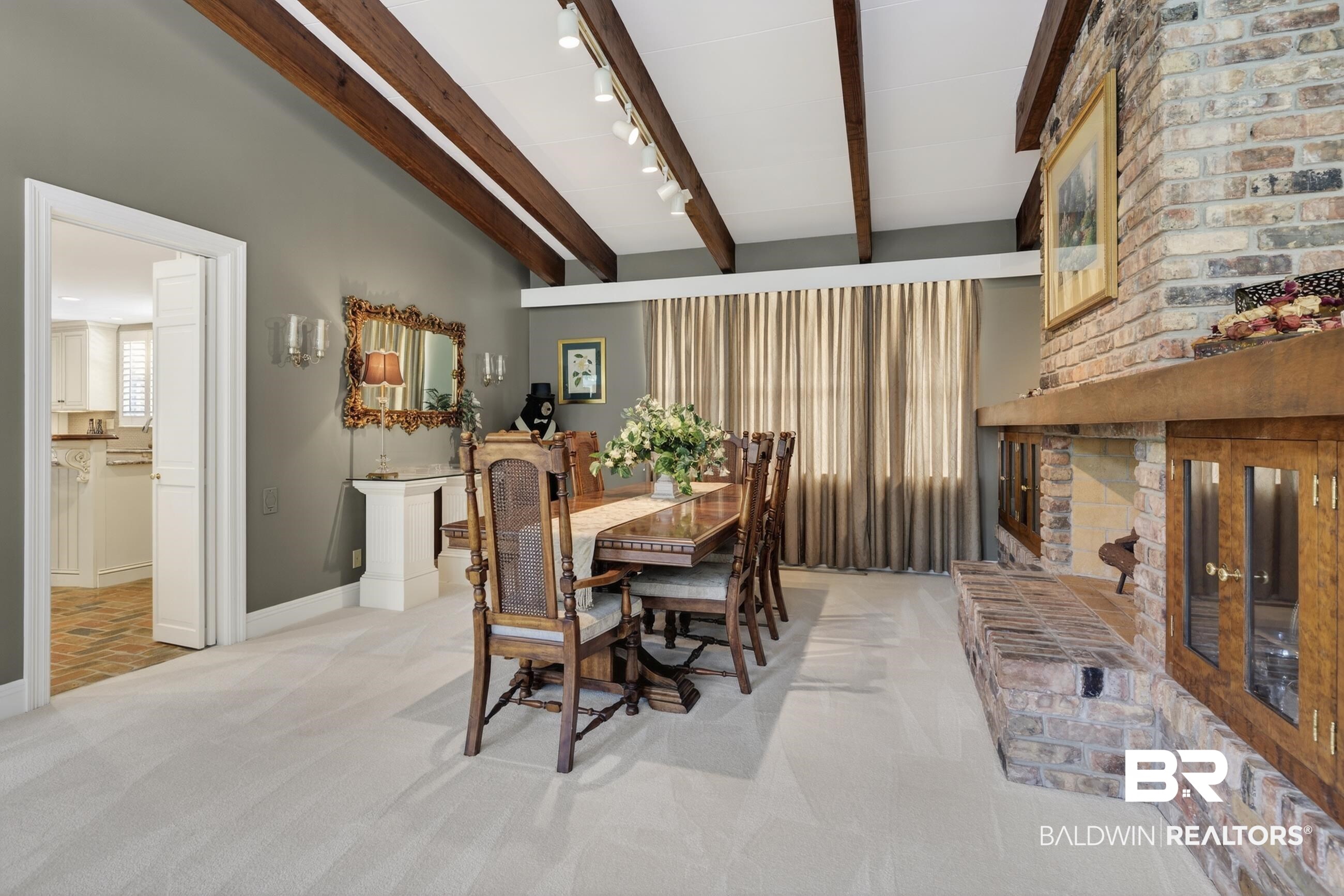 3175 Dawes Lake Road Mobile, AL 36619 - Photo 38 of 92 Dining space with rail lighting, light carpet, a brick fireplace, and lofted ceiling with beams