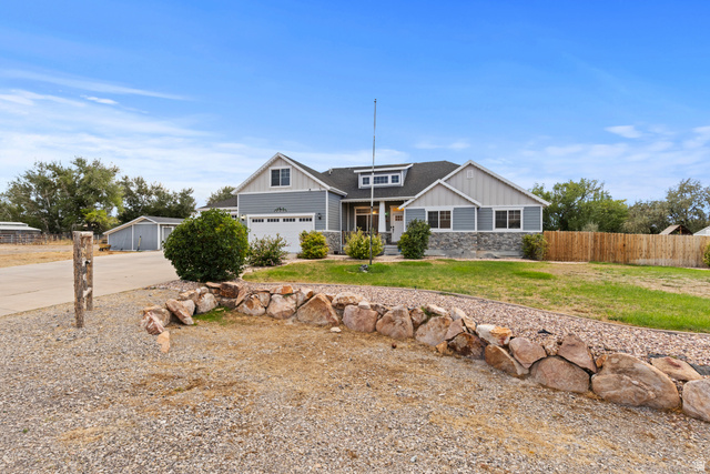 4557 North Ranch Road East Tooele, UT 84074 - Photo 2 of 43 Craftsman-style home featuring a stone facade, horizontal siding, and a gabled roofline