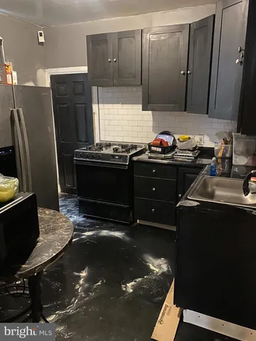 a kitchen with a stove and a refrigerator