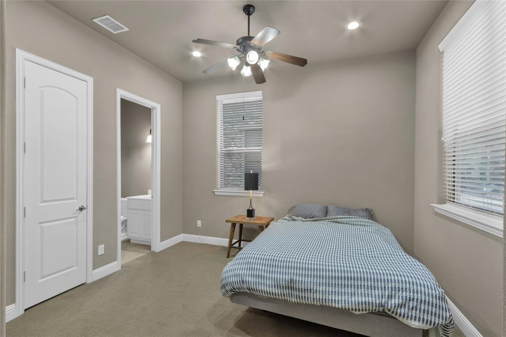 5724 Robbie Road Plano, TX 75024 - Photo 13 of 29 a bedroom with a bed and a chandelier