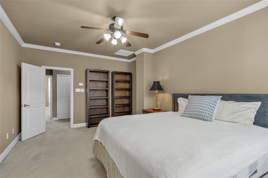 5724 Robbie Road Plano, TX 75024 - Photo 21 of 29 a bedroom with a large bed and a chandelier