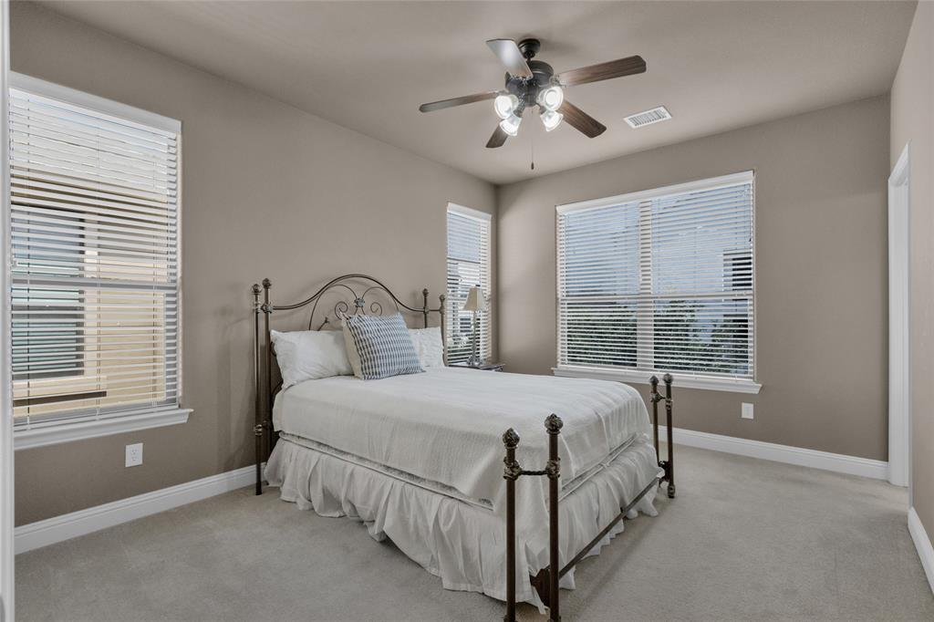 5724 Robbie Road Plano, TX 75024 - Photo 26 of 29 a bed sitting in a bedroom next to a window