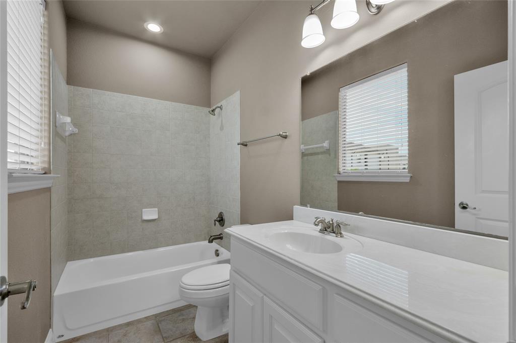 5724 Robbie Road Plano, TX 75024 - Photo 27 of 29 a bathroom with a sink a toilet and shower