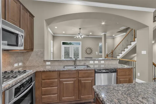 a kitchen with granite countertop a sink and stove