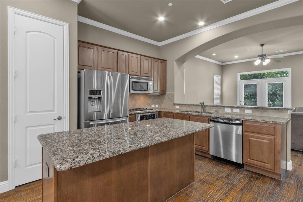 5724 Robbie Road Plano, TX 75024 - Photo 6 of 29 a kitchen with stainless steel appliances granite countertop a sink stove and refrigerator