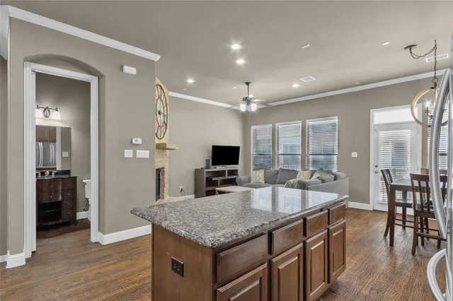 a large kitchen with kitchen island a large island in it