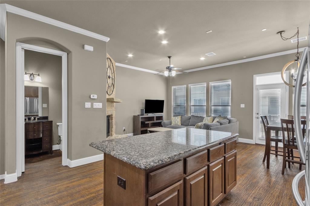 5724 Robbie Road Plano, TX 75024 - Photo 7 of 29 a large kitchen with kitchen island a large island in it