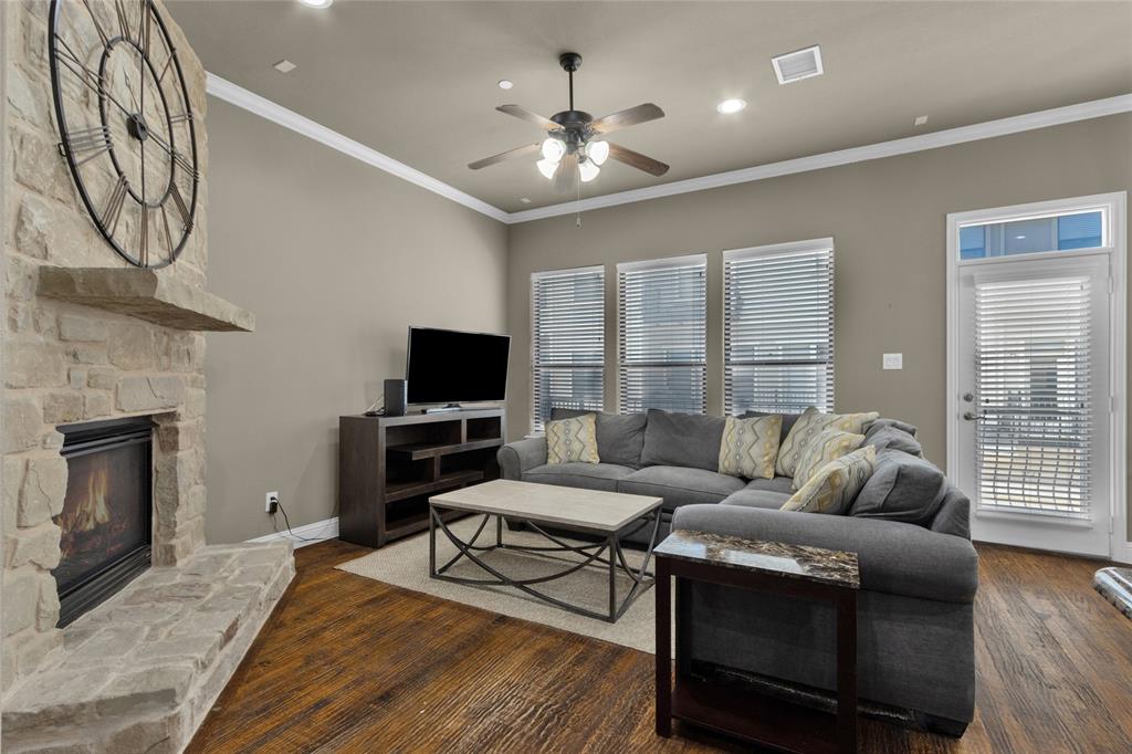 5724 Robbie Road Plano, TX 75024 - Photo 8 of 29 a living room with furniture a fireplace and a flat screen tv