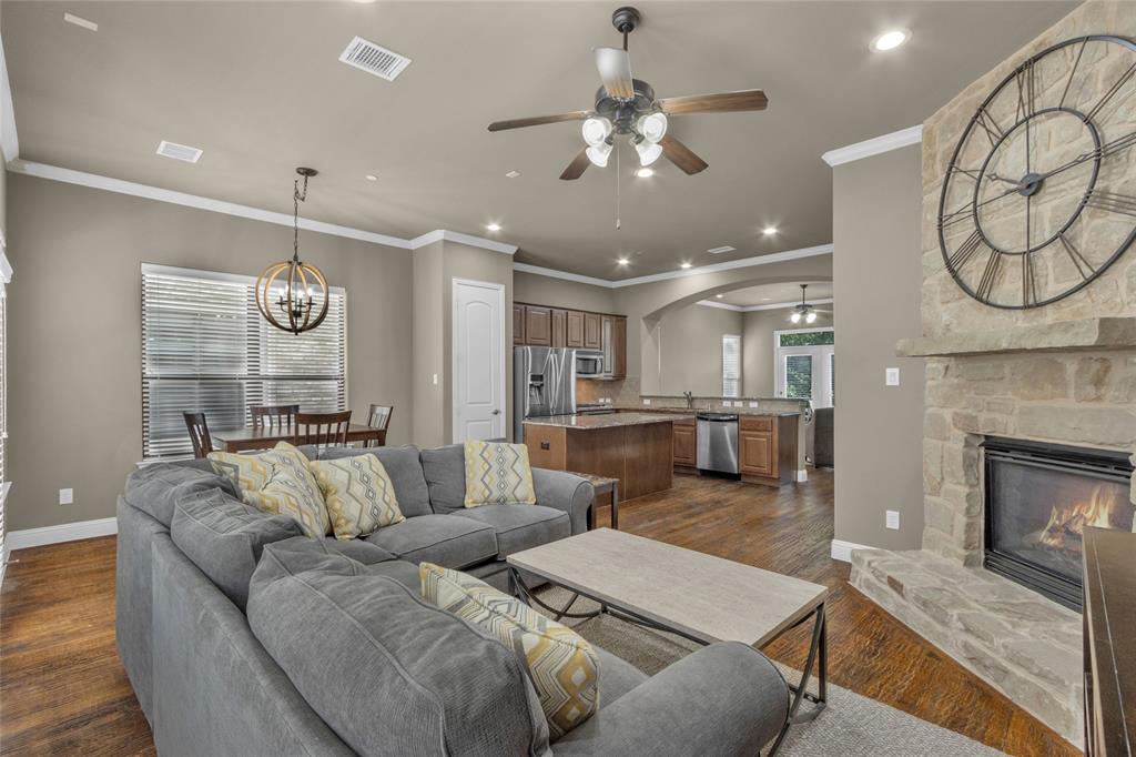 5724 Robbie Road Plano, TX 75024 - Photo 10 of 29 a living room with furniture and a fireplace