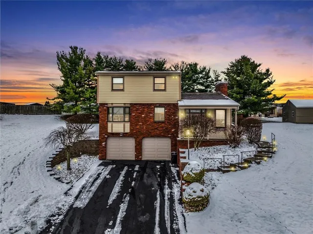 a view of a house with backyard and sitting area