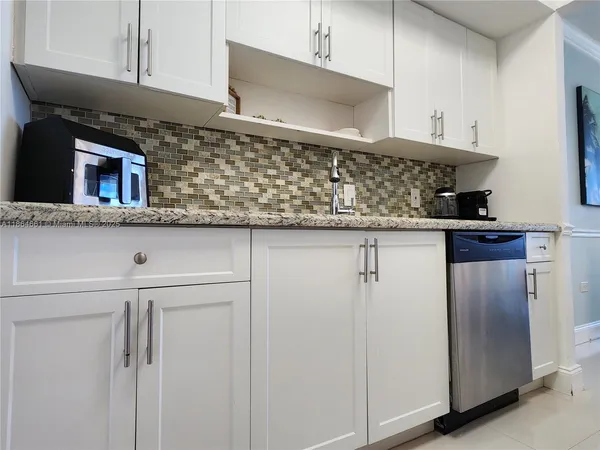 a kitchen with stainless steel appliances granite countertop a stove microwave and refrigerator