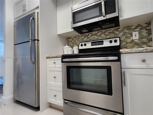 a bedroom with a bed and a view of living room