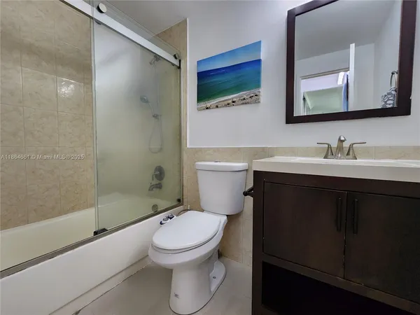 a bedroom with a bed next to a window