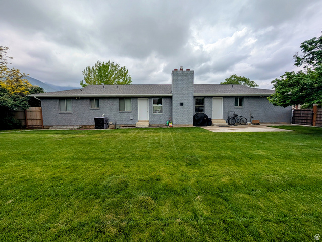 897 East 1200 North Mapleton, UT 84664 - Photo 20 of 54 Rear view of property featuring brick siding, a chimney, a patio area, and entry steps