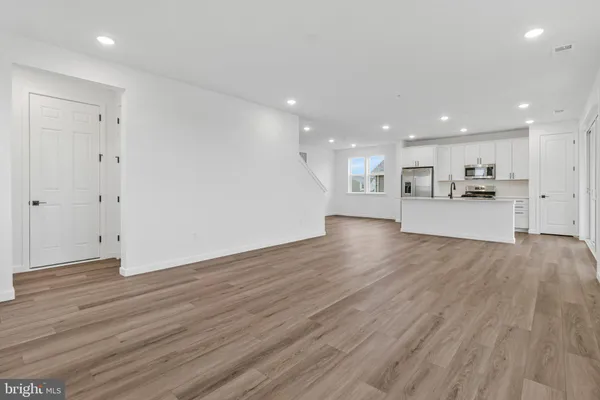 a view of a kitchen and dining room with wooden floor