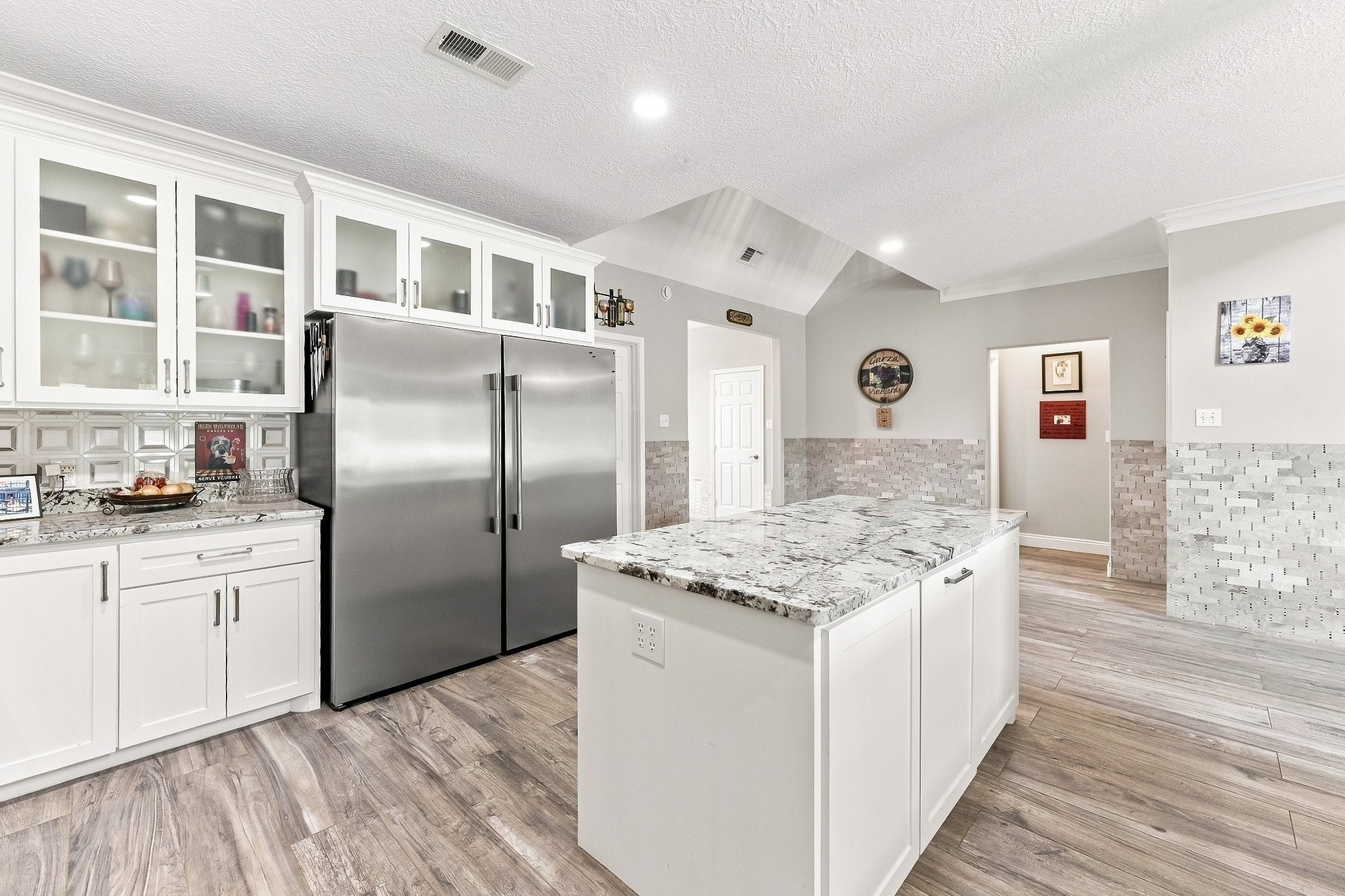 9010 Point Barrow Road Beach City, TX 77523 - Photo 8 of 50 Rich granite countertops command attention across the substantial prep surfaces, adding depth & sophistication to a kitchen created for elevated everyday living and entertaining.