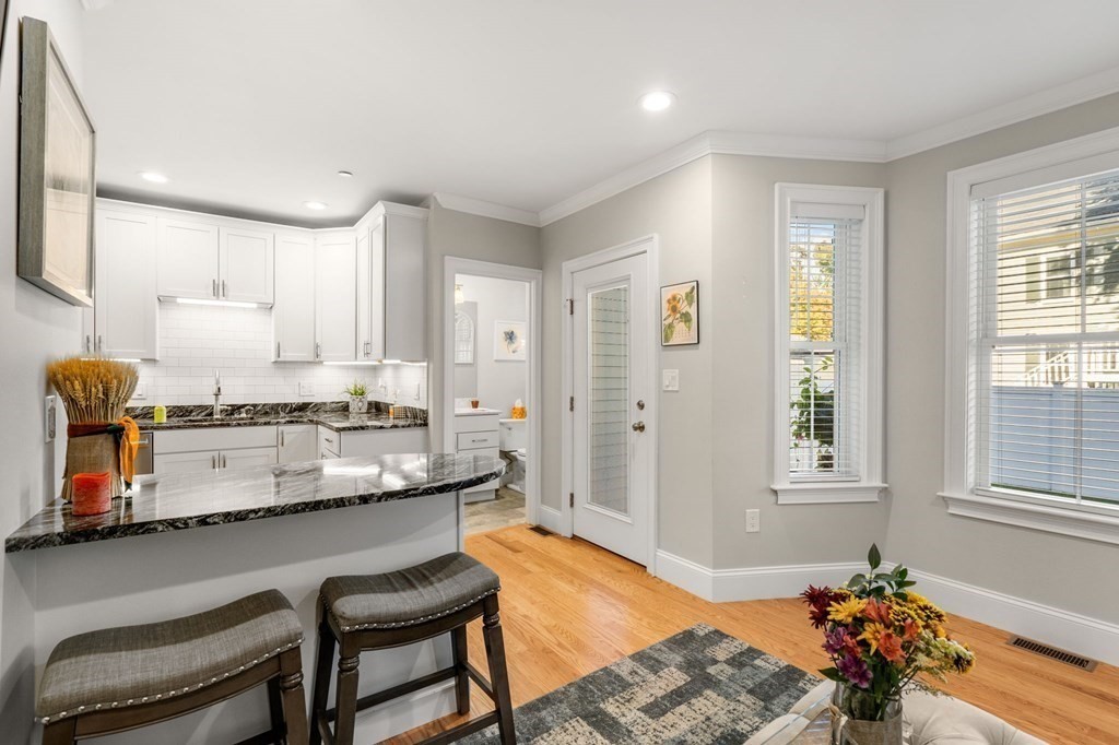 25 Cherry Street, Unit 3 Danvers, MA 01923 - Photo 11 of 27 a kitchen with granite countertop a stove a sink and a refrigerator