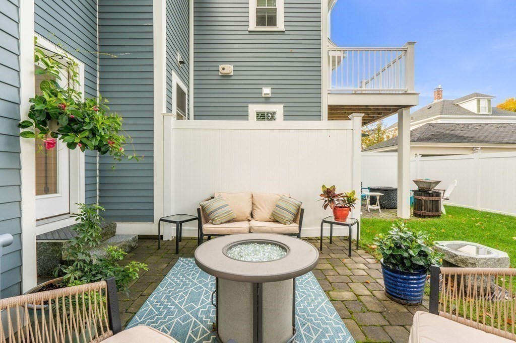 25 Cherry Street, Unit 3 Danvers, MA 01923 - Photo 12 of 27 a view of a chairs and table in back yard of the house