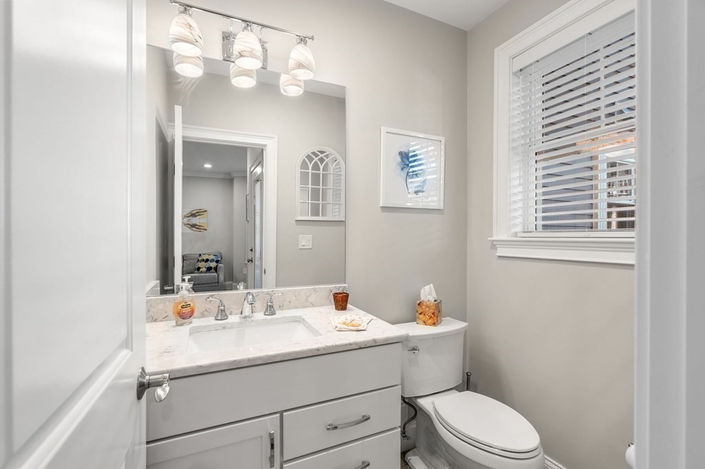 25 Cherry Street, Unit 3 Danvers, MA 01923 - Photo 14 of 27 a bathroom with a toilet sink and mirror